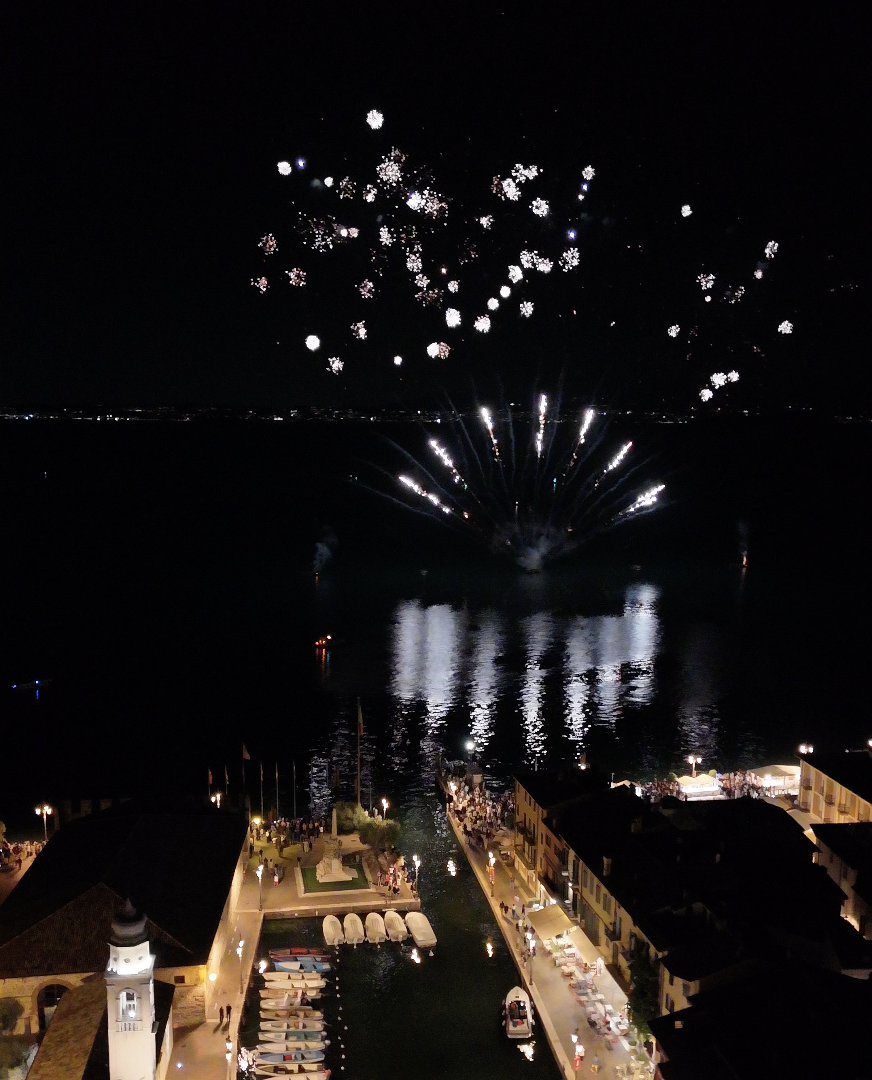 Fuegos artificiales sobre el puerto de Lazise vistos desde lo alto durante la Festa dell'Ospite